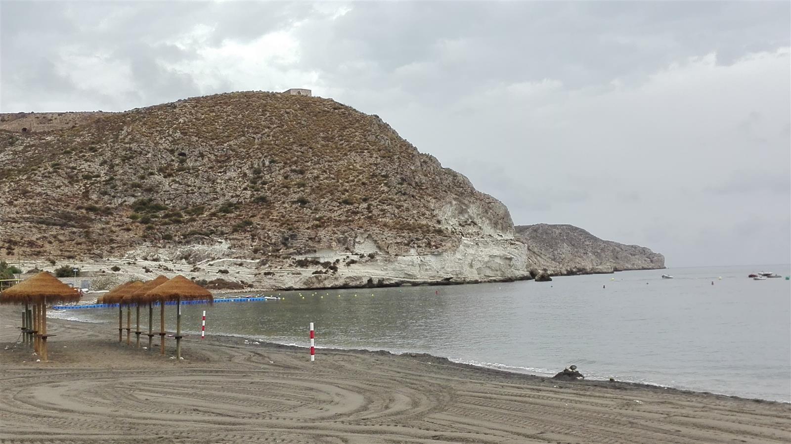 Costa de Agua Amarga con acantilados de roca volcánica oscura y el mar Mediterráneo en calma
