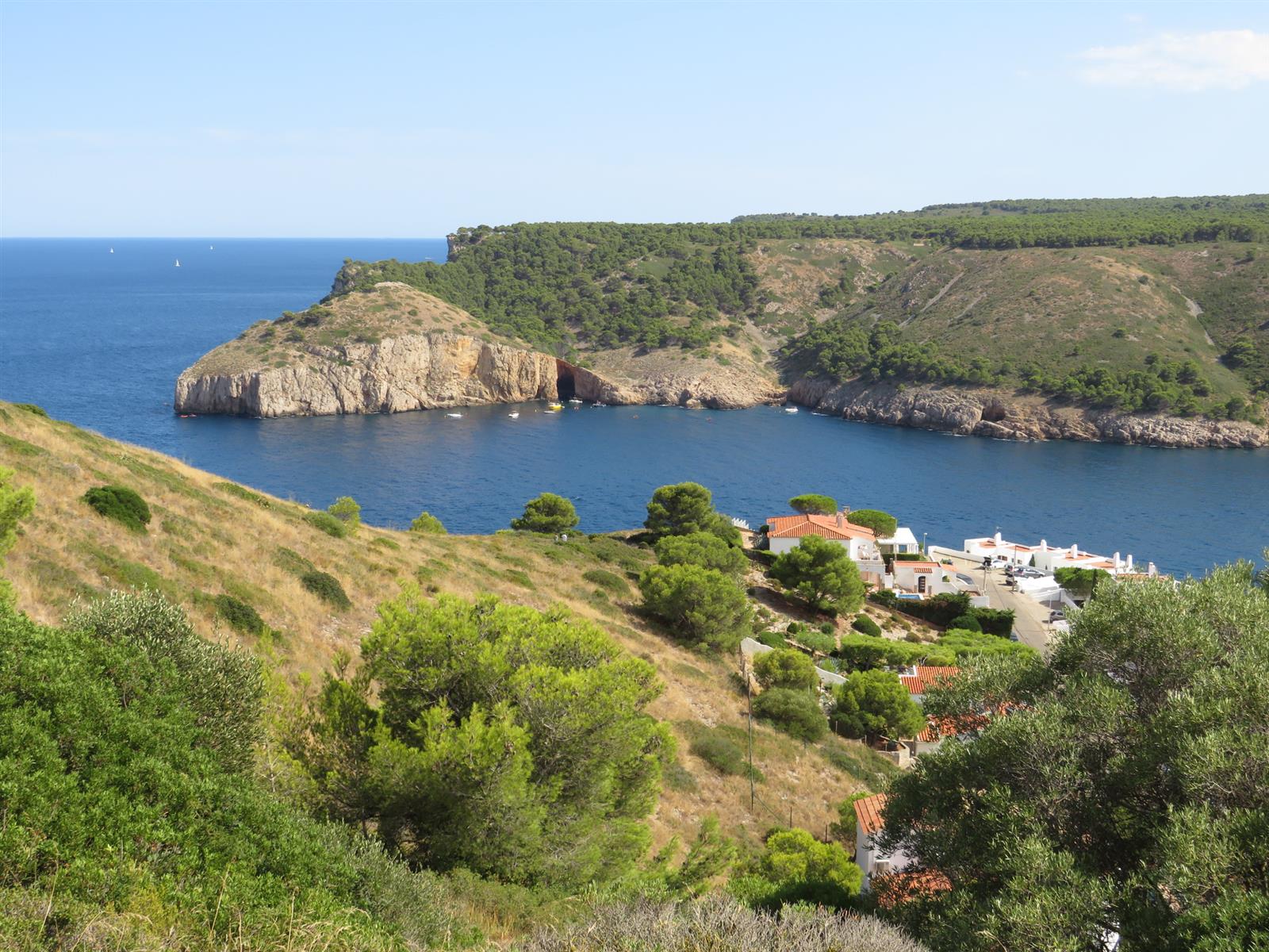 Cala Montgó vista desde la Punta del Milà con los acantilados mediterráneos, pinos y el mar abierto al fondo, L'Escala, Girona