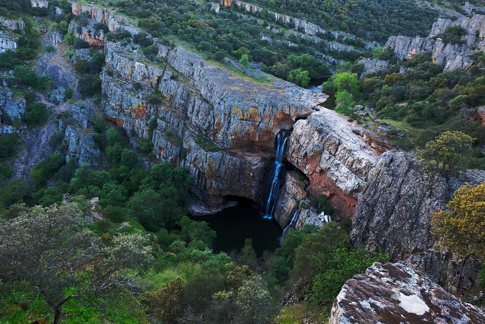 Cascada de la Cimbarra en Aldeaquemada, Jaén: salto de agua sobre pared de cuarcita roja en Sierra Morena