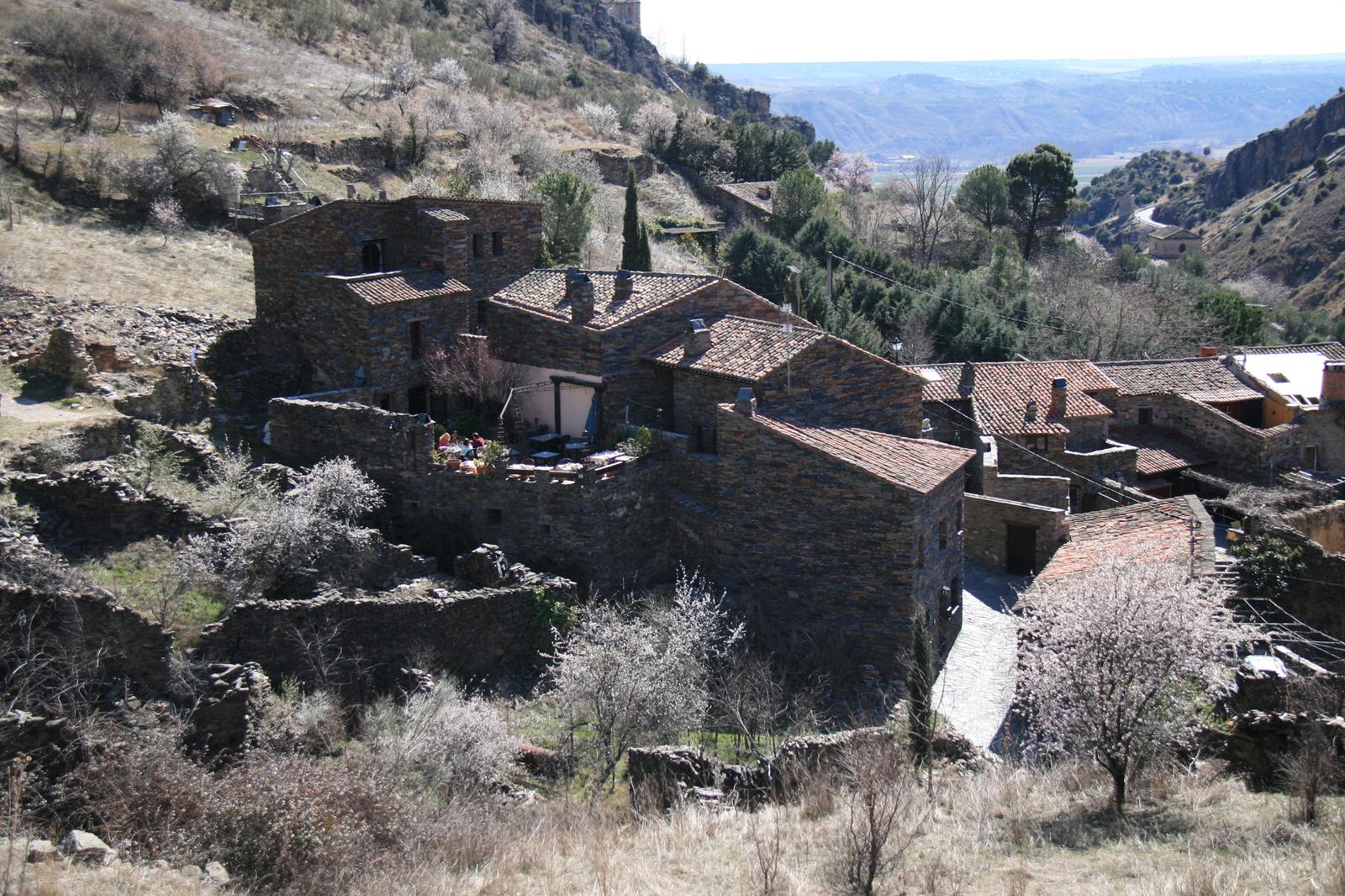 Vista elevada del casco de pizarra de Patones de Arriba sobre la ladera, con el valle al fondo
